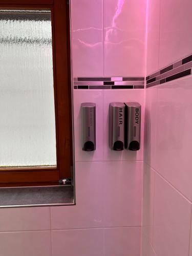 a pink bathroom with a mirror and a pink wall at Bähnleblick Blumberg in Blumberg