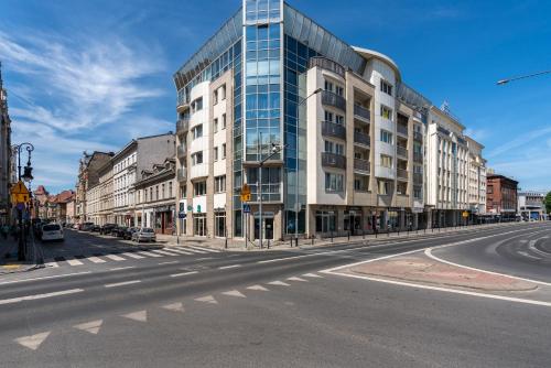 an empty city street with a large glass building at Modern&Cozy Garbary Apartment with Parking and Balcony by Renters in Poznań