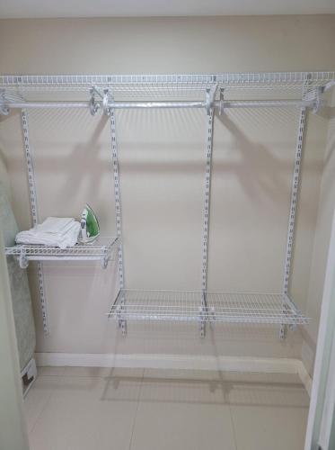 a white shelf in a room with a white wall at Impeccable 2-BR Apartment-Ornella Villa at Bayfront Villa in Portmore