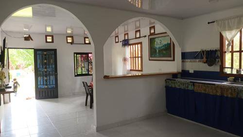 uma cozinha com paredes azuis e brancas e uma entrada em casa en la estación cocornà em Puerto Triunfo
