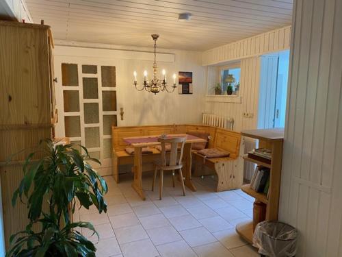 a kitchen with a table and a dining room at Pension Sandfeld in Teterow