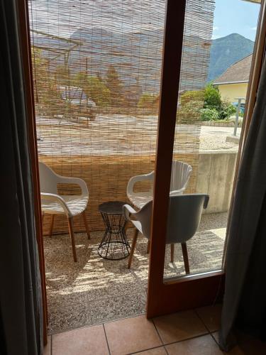 a view of a patio with chairs and a table at Apartments Rombon in Bovec