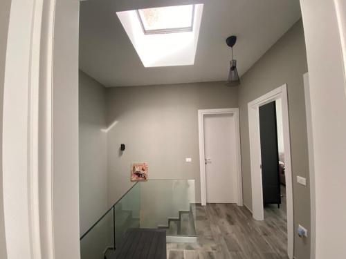a skylight in the ceiling of a room with stairs at Private Villa at Olea Luxury Resort in Dhërmi