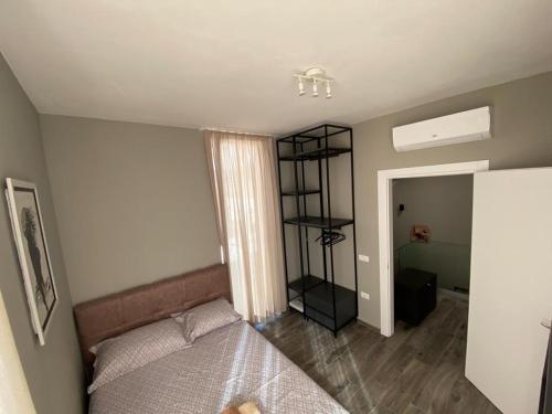 a bedroom with a bed and a book shelf at Private Villa at Olea Luxury Resort in Dhërmi