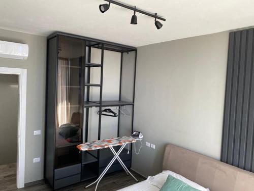 a bedroom with a black book shelf and a bed at Private Villa at Olea Luxury Resort in Dhërmi