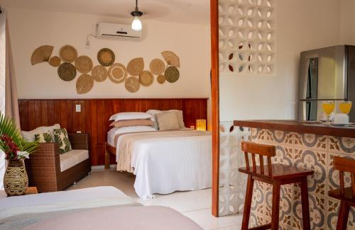 a room with two beds and a mirror at Swiss Garten Jeri in Jericoacoara