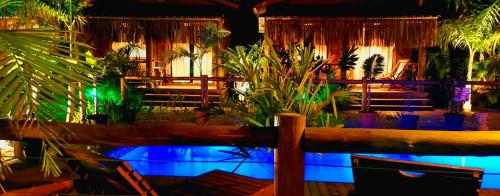 a room with a pool with plants in it at ॐ Rosa Astral ॐ in Praia do Rosa