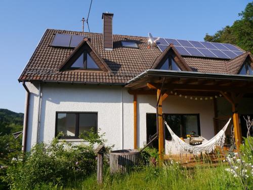 a house with solar panels on the roof at Ferienwohnung Waldschloss in Eppenbrunn