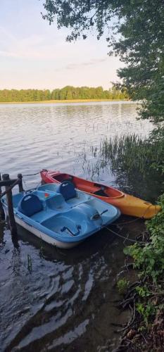 a group of kayaks are sitting on the water at SORKWITY- Pensjonat - STARY GIELĄD in Sorkwity