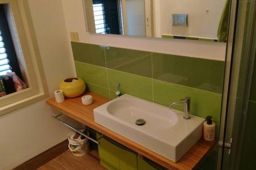 a bathroom with a sink and a mirror at Sapore di sale in Cava dʼAliga