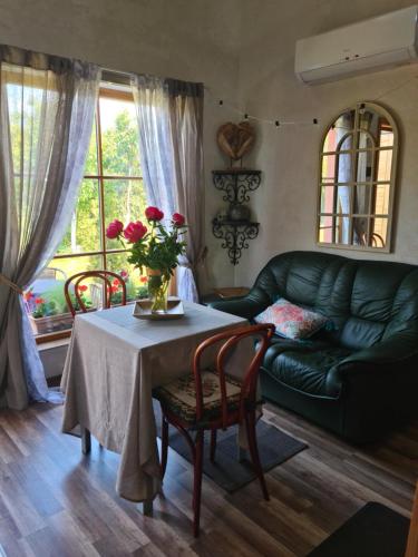 a living room with a table and a couch at Vila Šventoji in Šventoji