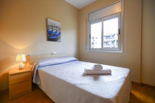 a bedroom with a bed and a window at JOEL 2 Planetcostadorada ONLY FAMILIES in Salou