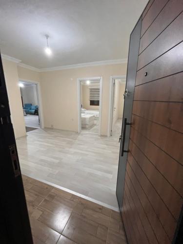an empty room with a door leading to a living room at MAVİ KÖŞK UZUNGÖL in Uzungöl