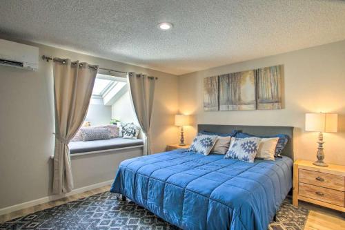 a bedroom with a blue bed and a window at Stoneridge Resort in Blanchard