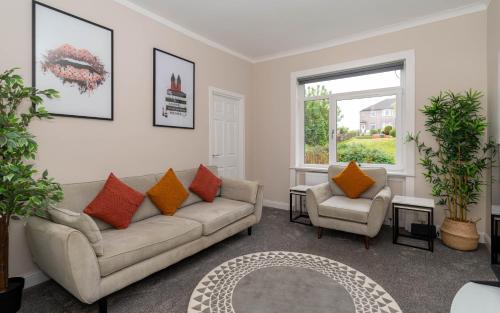 a living room with a couch and two chairs at 4 Bedrooms Homely House - Sleeps 6 Comfortably with 6 Double Beds,Glasgow, Free Street Parking, Business Travellers, Contractors, & Holiday-Goers, Near All Major Transport Links in Glasgow & City Centre, Perfect for Common Wealth Games 2026 in Glasgow