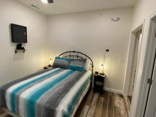 a bedroom with a bed and a tv on the wall at Hermann Crown Suites in Hermann