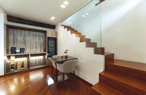 a staircase in a house with a chair and a table at Soul of Trento Vicolo del vo' in Trento