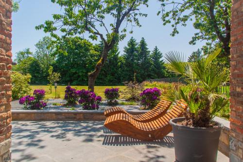 two wooden benches sitting in a garden with flowers at Gîtes de la Chapelle in Assesse