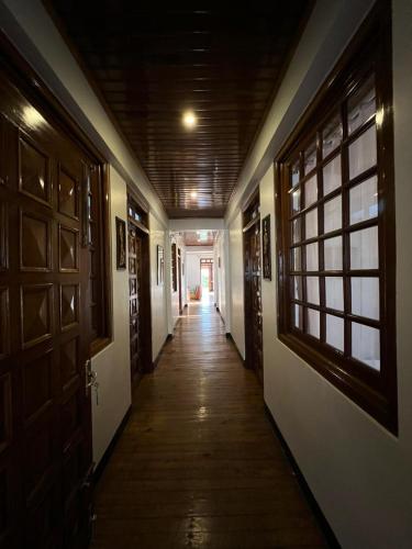 a hallway with wooden doors and a hallway sidx sidx sidx at BelleVue Home Stay in Shillong