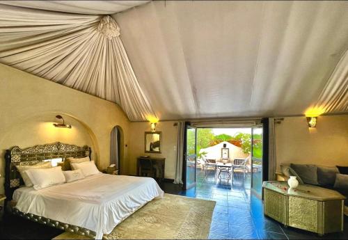 馬拉喀什的住宿－Les jardins d isis，一间卧室设有一张床和一间客厅。