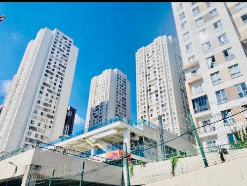 three tall white buildings in a city at Full 2 bedroom apartment in luxury complex in Esenyurt