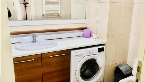 a bathroom with a washing machine and a sink at Full 2 bedroom apartment in luxury complex in Esenyurt