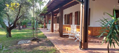 a porch of a house with chairs on it at Elisa Holidays in Puegnano del Garda
