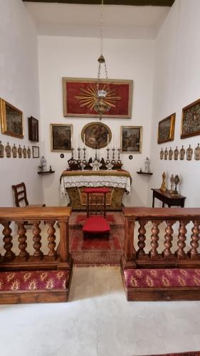 a living room with a fireplace and two benches at Palazzo del Prelato in Mdina