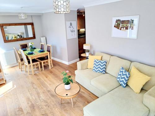 a living room with a couch and a table at Tottenham Spur Hideaway in London