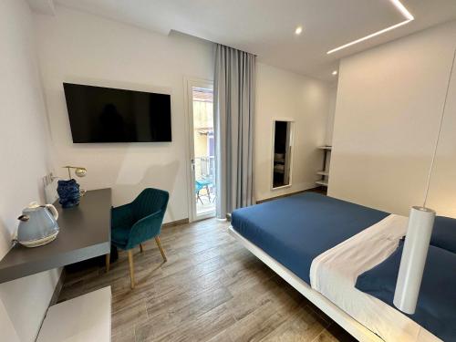 a bedroom with a bed and a desk and a television at B&B Altomare in Lampedusa