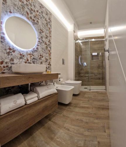 a bathroom with a shower and a sink and a mirror at B&B Altomare in Lampedusa