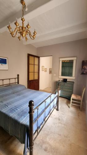 a bedroom with a large bed and a chandelier at Palazzo del Prelato in Mdina