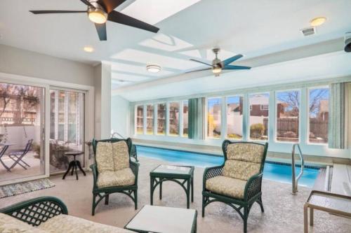 a living room with a pool and a ceiling fan at 3 bedroom w indoor pool hotub in Silver Spring