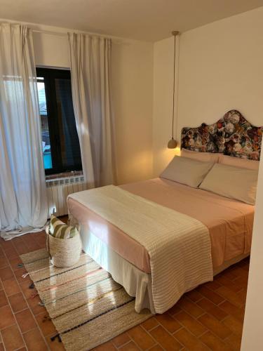 a bedroom with a large bed and a window at Casetta Valmora in Valpiana