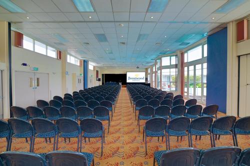 an empty room with chairs and a projection screen at Brentwood Hotel in Wellington