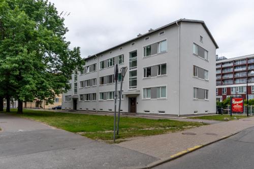 a large white building on the side of a street at Studio in the heart of Pärnu, free parking! in Pärnu