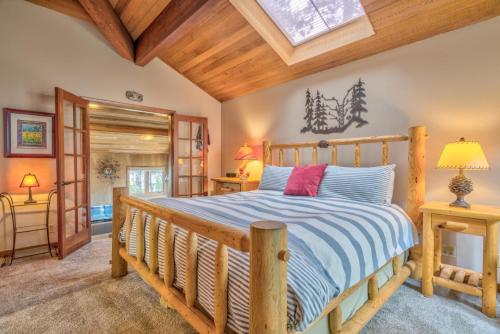 a bedroom with a wooden bed in a room at Tan Oak - Unit 37 in Sunriver