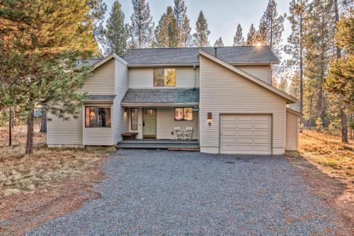 a house with a garage in the woods at Towhee - Unit 5 in Sunriver