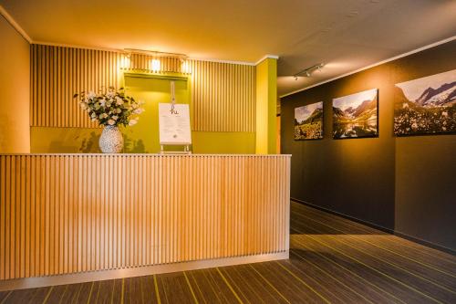 a lobby with a vase of flowers on a counter at Norway Holiday Apartments - Norddalstunet in Norddal