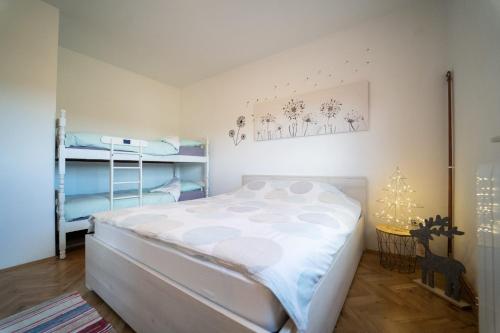 a bedroom with a bed and two bunk beds at House Malkoc in Saborsko