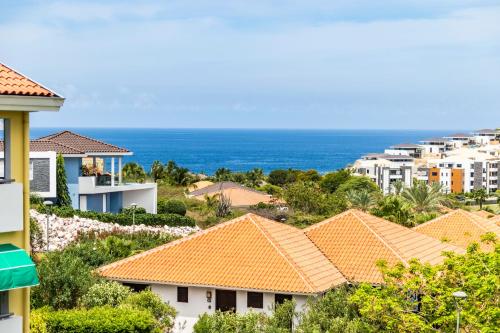 a view of houses and the ocean at Triple Tree # 7 in Blue Bay