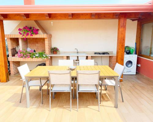 a kitchen and dining room with a table and chairs at La Casa Di Rosa in Oliveri