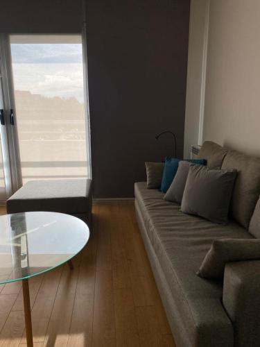 a living room with a couch and a glass table at Puravida DOHO cerca de todo in Buenos Aires