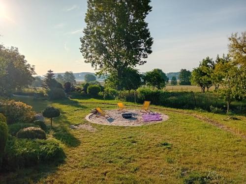 a garden with a fire pit in the middle of a field at Chatka Święty Spokój in Piotrowice