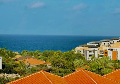 a view of a city with houses and the ocean at Triple Tree # 7 in Blue Bay