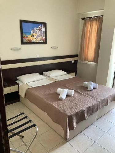 a bedroom with a bed with two towels on it at VILLA HARIKLIA in Paralia Katerinis