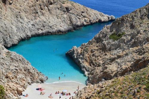 a group of people on a beach in a canyon at CARA Creta Home in Kolymvari