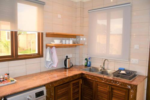 a kitchen with a sink and a counter top at 3 Bedroom Luxury Villa-Sita in Diani in Kinondo