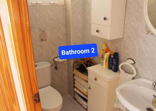 ein Badezimmer mit einem weißen WC und einem Waschbecken in der Unterkunft Sol Apartment in Arenales del Sol
