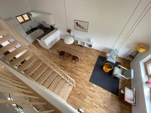 an overhead view of a living room and a staircase at Gamsfels Petronella Galeriewohnung in Langen bei Bregenz